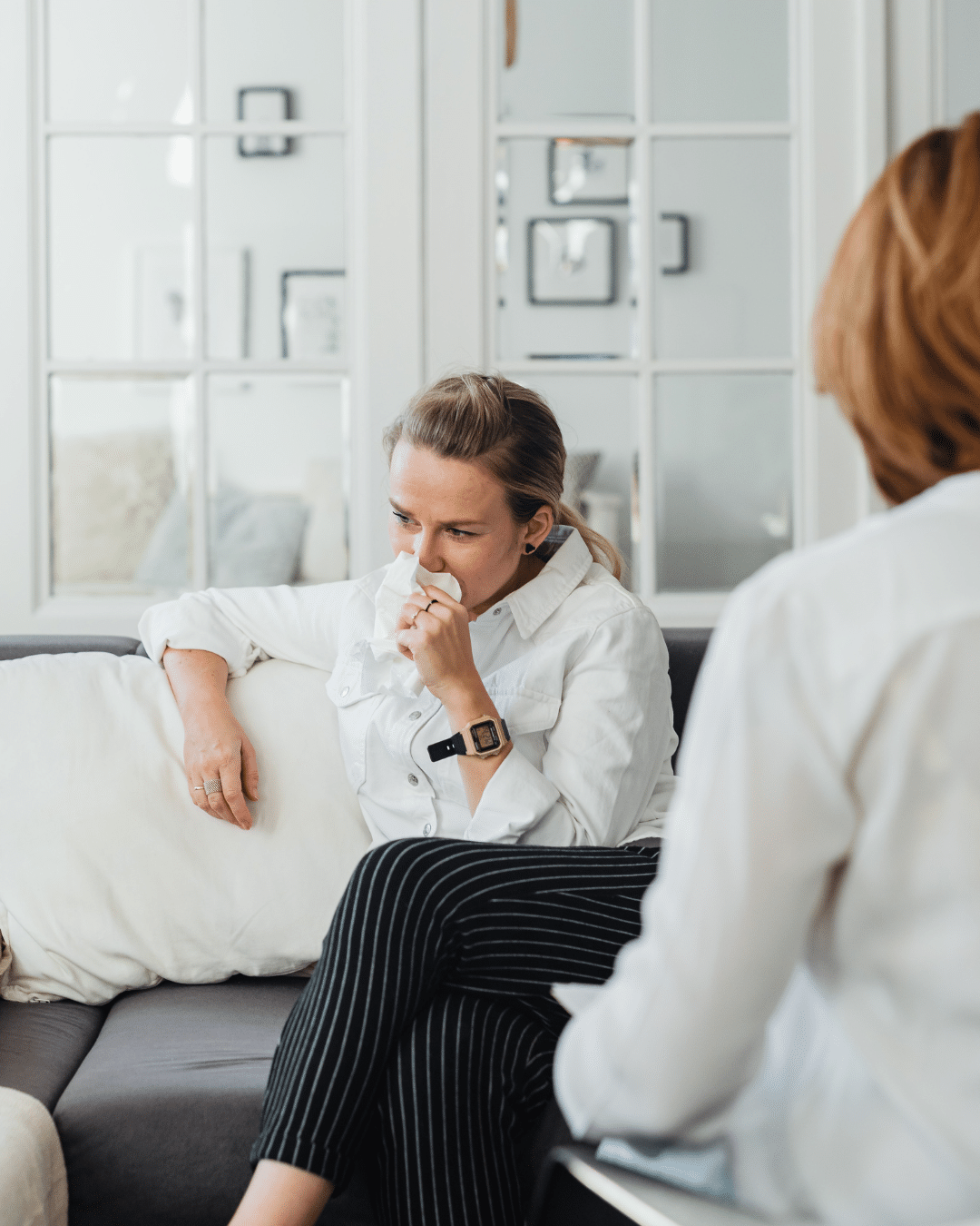 Woman in a trauma therapy session with a licensed PTSD therapist
